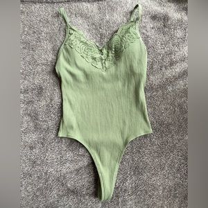 PINK thong body suit.